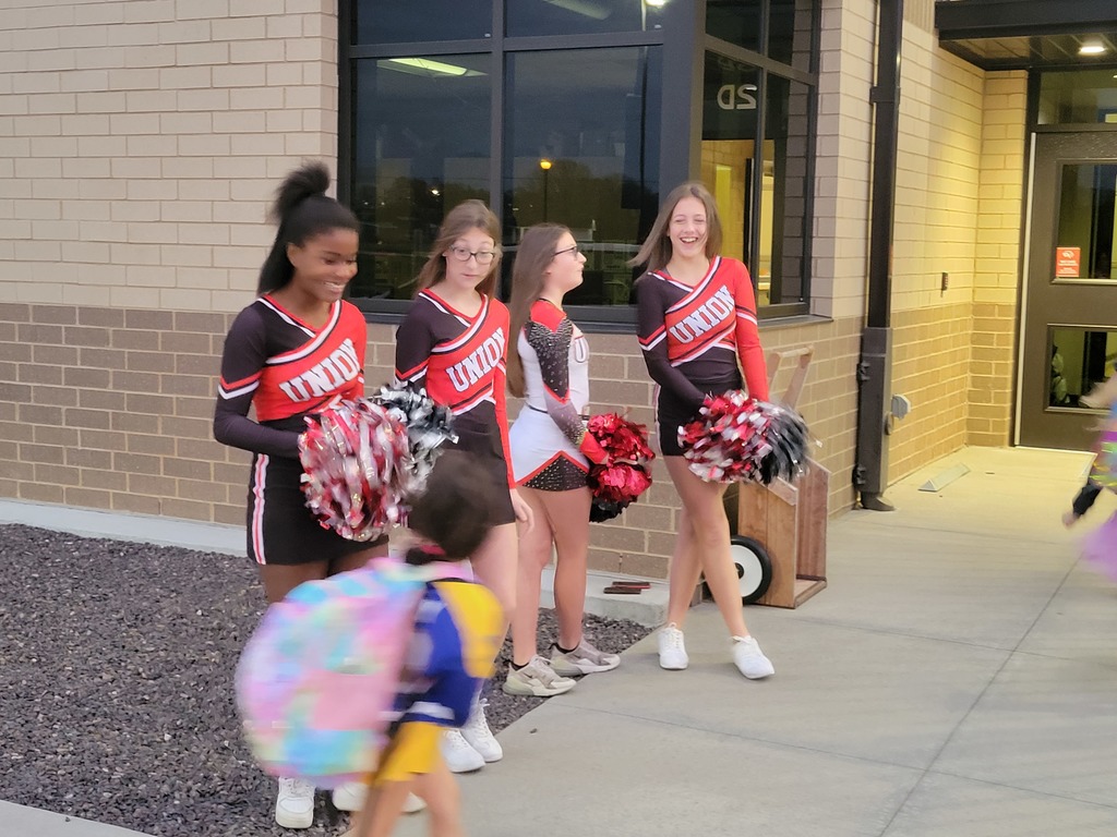 Cheerleaders welcoming students